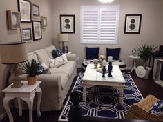 a living room filled with furniture and pictures on the wall