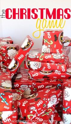 a pile of wrapped presents sitting on top of each other in front of a christmas sign