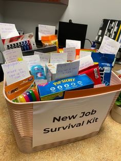 a new job survival kit in a basket on a counter top with notes and pens