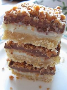 three pieces of cake sitting on top of a white plate