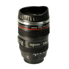 a camera lens coffee mug sitting on top of a table