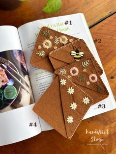 the book is open to show an image of some food and flowers on top of it