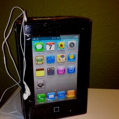 an ipod sitting on top of a table with ear buds attached to the back of it