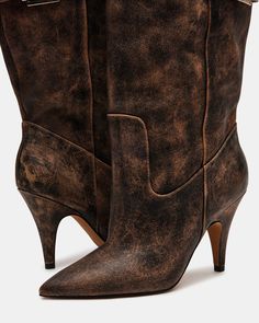 Expertly crafted, the BADDIE boot is both edgy and practical. Made with a pointed toe and buckle detail, these over-the-knee heeled boots offer a unique touch to any outfit. Elevate your style with these statement boots. 3.5 inch heel height Size 6 measurements: 16.5 inch shaft circumference, 22 inch shaft height Size 8 measurements: 17.25 inch shaft circumference, 22.5 inch shaft height Size 10 measurements: 18 inch shaft circumference, 23 inch shaft height Leather upper material Vegan leather Chic Wide Calf Heeled Boots With Snip Toe, Chic Snip Toe Knee-high Boots For Fall, Chic Moto Boots With Reinforced Heel And Pointed Toe, Edgy Knee-high Heeled Boots For Work, Vintage Pointed Toe Mid-calf Boots For Fall, Chic Knee-high Boots With Stacked Heel And Snip Toe, Chic Knee-high Boots With Snip Toe And Stacked Heel, Fall Vintage Heeled Boots With Pointed Toe, Fall Knee-high Boots With Pointed Toe