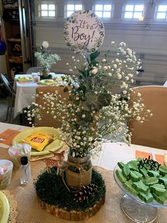 a table topped with plates and vases filled with flowers next to a sign that says it's you