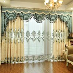 a living room with wood flooring and curtains on the windowsill, along with a chandelier