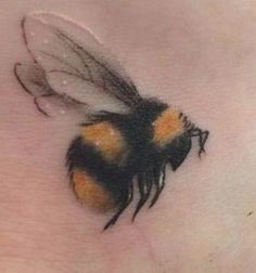 a close up of a bee on the side of a woman's stomach