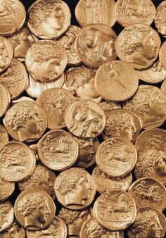 a pile of gold coins sitting next to each other