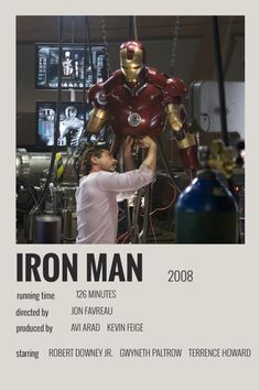 the iron man movie poster is being worked on by a man in a white shirt