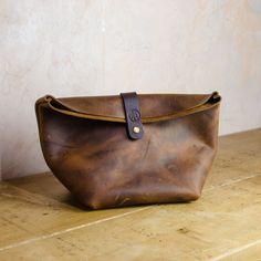 Introducing our Handmade Leather Toiletry Bag, the prefect companion for the modern traveller. Crafted with Premium Quality Kodiak Leather and attention to detail, this toiletry bag is both stylish and durable, its spacious interior allows you to neatly organise your essentials while the durable construction ensures long lasting use. Treat yourself or surprise a loved one with this  functional Bag that combines fashion and functionality effortlessly. Finished with dark brown vegetable-tanned lea Brown Leather Handle Travel Pouch, Brown Pouch Camera Bag For Everyday Use, Everyday Use Brown Pouch Camera Bag, Everyday Brown Pouch Camera Bag, Leather Handle Clutch For Travel, Rectangular Travel Pouch With Leather Handles, Brown Leather Handle Pouch For Everyday Use, Brown Zipper Pouch Bag For Everyday, Modern Brown Shoulder Bag With Zipper Pouch