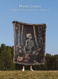 a person standing in front of a tapestry with a skeleton on it