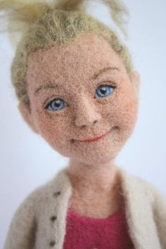 a doll with blonde hair and blue eyes