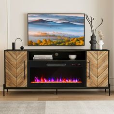 an entertainment center with a fireplace in the middle and a flat screen tv above it