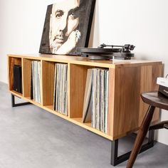 a record player sitting on top of a wooden shelf