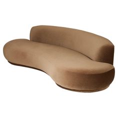 the curved couch is made out of suede fabric and has a rounded backrest