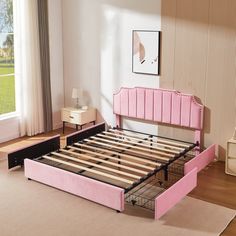 a bed with pink headboard and foot board in a room next to a window