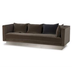 a brown couch with black pillows on it