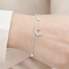 This sterling silver crescent moon and star bracelet showcases sparkling stars shining with zircon accent stones. It is the perfect touch of sparkle and shine his sterling silver crescent moon and star bracelet showcases sparkling stars shining with zircon accent stones. It is the perfect touch of sparkle and shine. Product Name Sterling Silver Moon & Star Believe Bracelet Main Material Sterling Silver 925 & Zircon Size: 6.5 in with extender 7.68 in Feature Sterling Silver 925, Nickel & lead Fre Celestial Silver Charm Bracelet, Sterling Silver Bracelets With Moon Charm, Celestial Silver Bracelet With Star Charm, Silver Celestial Bracelet With Star Charm, Sterling Silver Celestial Bracelet With Moon Charm, Sterling Silver Moon Charm Bracelet, Elegant Sterling Silver Bracelets With Moon Charm, Celestial Crescent Silver Bracelets, Crescent Moon And Star