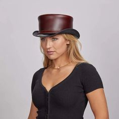 Hampton | Womens Leather Top Hat offers a sophisticated look with its midweight cowhide top grain leather and cinched deerskin lacing. Perfect for adding a unique, polished touch to any outfit. Material: Midweight USA Raised Cowhide Top Grain Leather Shape: Top Hat Trim: Leather Band; Cinched with Deerskin Lacing Brim Size: 2” Crown Height: 4 3/4” Sweatband: AHM Velcro Assembled in the USA Leather Top Hat, American Hat Makers, New Hampton, Hat Style, More And More, Steam Punk, Pull Up, Top Hat, Leather Top