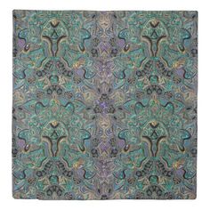 an intricately designed square scarf with blue, green and purple colors on the front