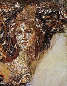 a close up of a mosaic on the side of a building with an image of a woman