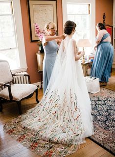 the bride is getting ready to walk down the aisle in her wedding dress and veil