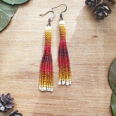 the earrings are made with seed beads and beaded in red, yellow, and white