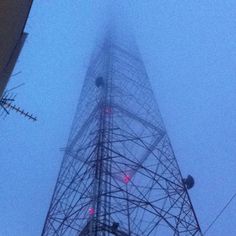 the top of a tall tower covered in fog