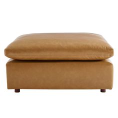 a tan leather ottoman with wooden legs