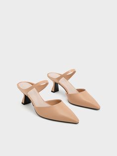 Adding subtle design twists to a workwear staple by way of slant heels and curved straps, these mules are a wardrobe mainstay you will be reaching for on repeat. A clean white finish complements the curved lines and sleek silhouette of these shoes perfectly, while the slant heels offer a sculptural lift. Bonus points for the pointed toes, which have a subtle leg-lengthening effect. This product is made with water-based faux leather, which requires less energy to produce than regular faux leather. Pollution-free, non-toxic and free of harmful chemicals, it creates a smaller carbon footprint. Heel Mules, Faux Leather Heels, Size Chart For Kids, Curved Lines, Charles Keith, On Repeat, Belt Size, Hobo Bag, Heel Height