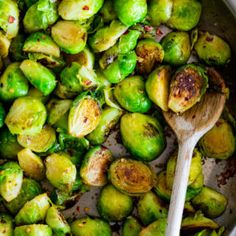 brussel sprouts in a pan with a wooden spoon