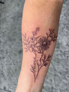 a woman's arm with flowers on it