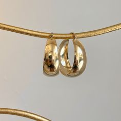 14KT yellow gold wide + chunky, tapered hoop earrings. Medium size round hoops with yummy chunkiness to make a statement. Length: 27mm Width: 24mm Thickness: 10.5mm (at widest point) Tapers Weight: 3.50 grams Stamped 14K Wire + clutch backs Assorted Chunky Gold Earrings, Chunky Gold Hoop Earrings Minimalist, Gold Hoops Chunky, Hoop Earrings Medium, Chunky Silver Jewellery, Gold Hoops Earrings, Chunky Jewellery, Earrings Gold Hoops, Saint Jewelry