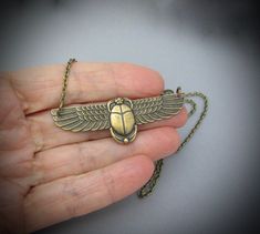 "Vintage design Egyptian Revival Scarab Pendant Necklace. Beautiful Antiqued brass. Ornate detailed Scarab, 2-3/8\" across. Antiqued brass finish brass chain with a lobster clasp. Handmade by me, on Maui, and sent to you with Aloha! #53 More of my Artisan Jewelry: hawaiibeads.etsy.com" Gold Stamped Metal Jewelry, Bronze Brass Necklace For Anniversary, Antique Finish Brass Necklace For Gift, Collectible Brass Necklace With Antique Finish, Bronze Stamped Brass Necklace, Stamped Bronze Brass Necklace, Antique Gold Stamped Jewelry Gift, Bronze Stamped Jewelry As A Gift, Gold Copper Necklace For Collectors