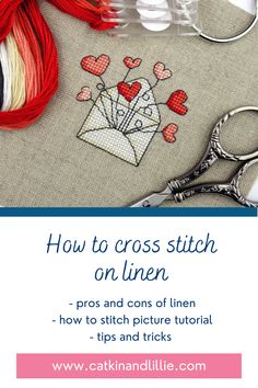 cross stitch on linen with scissors, thread and other crafting supplies in the background