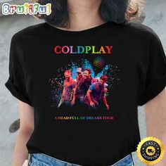 a woman wearing a black t - shirt with the words coldplay and three people on it