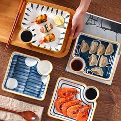 three trays with food on them and two people holding chopsticks