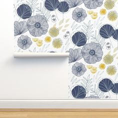 a wallpaper with blue and yellow flowers on white paper next to a wooden floor