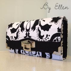 a black and white purse sitting on top of a counter