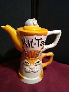 a yellow and white coffee cup with a cat on top