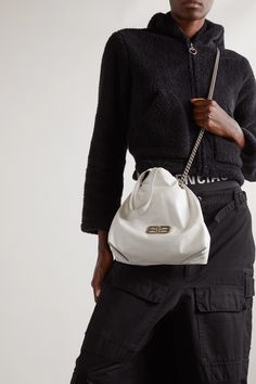 Balenciaga's shoulder bag is made from crinkled-leather that further emphasizes the slouchy bucket-like shape. Topped with logo hardware, it has a long silver-tone chain strap that threads through the drawstring top and can be doubled up or worn cross-body. The spacious interior can easily fit your phone, wallet and keys. Drawstring Top, Balenciaga Bag, Phone Wallet, White Bag, Net A Porter, Chain Strap, Women Collection, Monaco, Leather Shoulder Bag