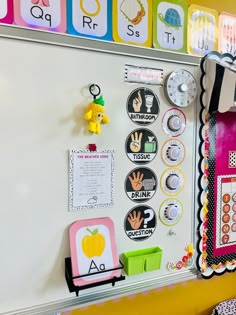 a white board with lots of magnets on it in a classroom area next to a yellow wall