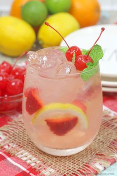 a close up of a drink with fruit in the background