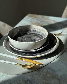 a table set with plates and silverware on top of it, next to a knife and fork