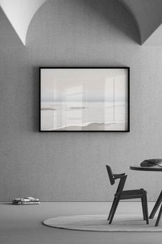 a black and white photo of a table with two chairs