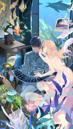 a man and woman are sitting in front of an aquarium