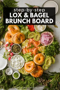 an assortment of food is laid out on a white counter top, including bagels and salads