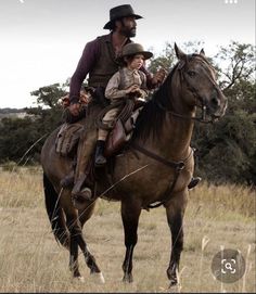 a man riding on the back of a brown horse next to a little boy wearing a hat