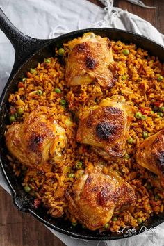 chicken and rice in a skillet on a wooden table