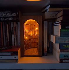 a bookshelf filled with lots of books next to a light that is on